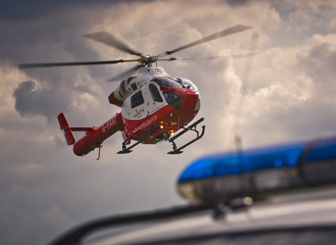 Emergancy helicopter hovering over an ambulance