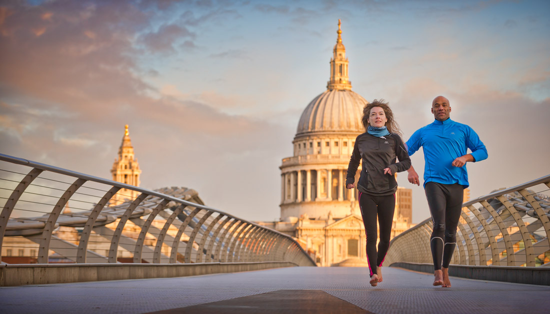 Two people running with St Paul's Cathedral in the background