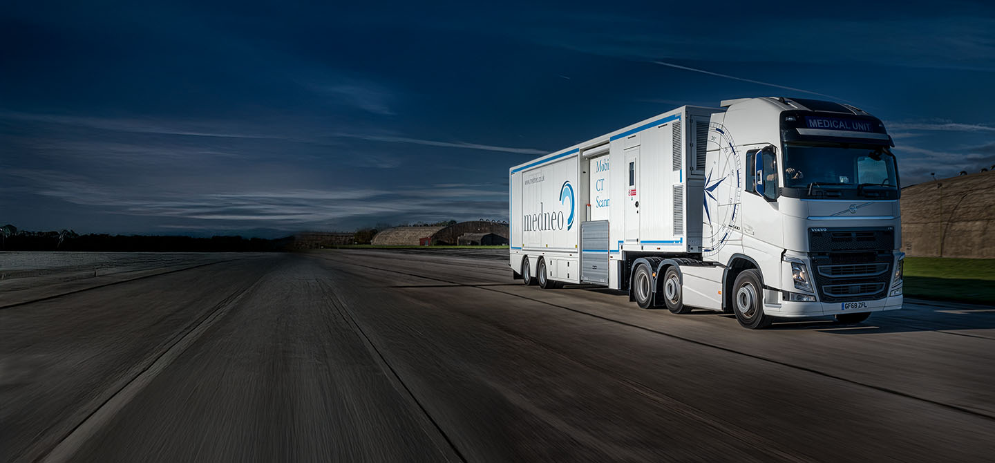 A large lorry photographed from another vehicle while being driven along a road.