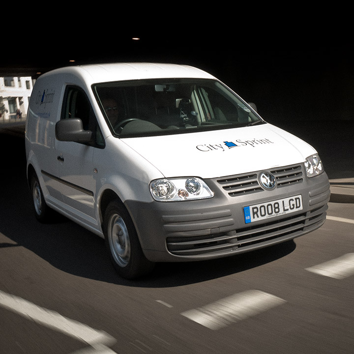 A small City Sprint van driving in London.