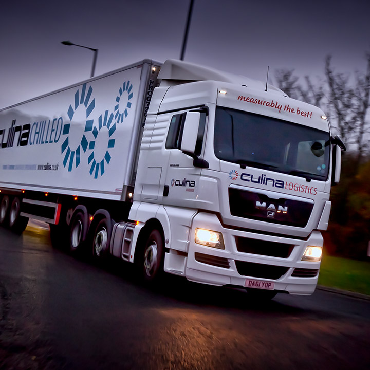 A lorry driving on a road in the evening in Essex.