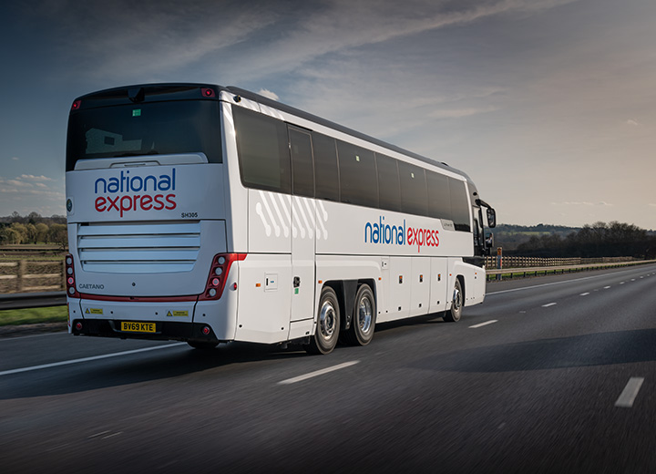 A large white coach travelling on a motorway in Essex