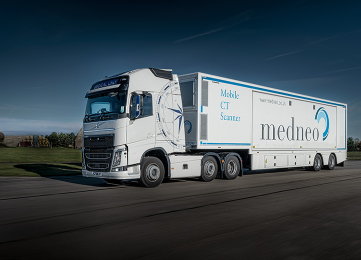 A medical lorry being driven in bright sunlight.