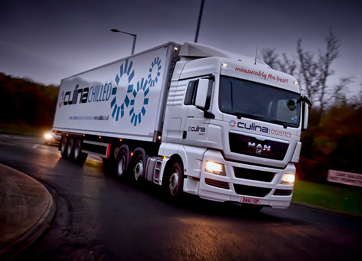 A logistics companies lorry in motion.