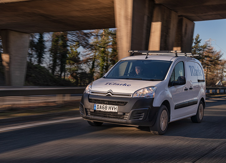 A contractors white van driving on a motorway.