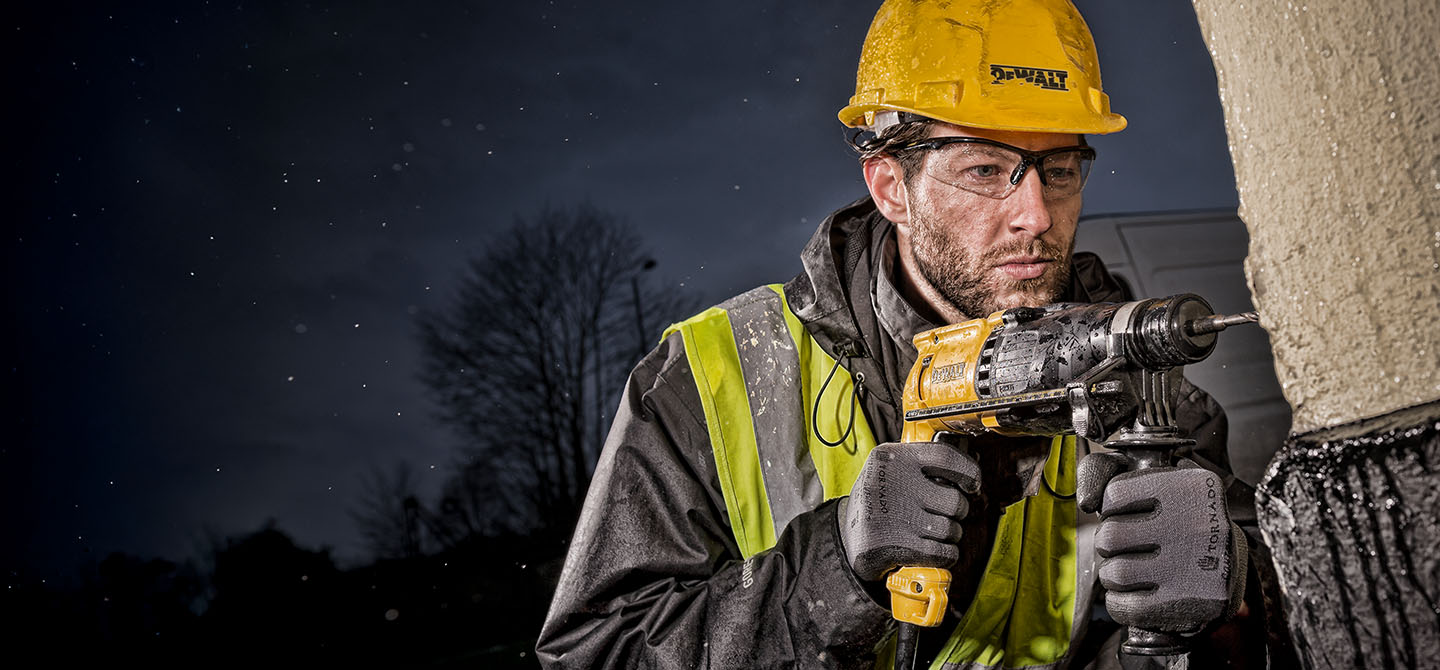 An example of commercial photography showing a worker with a deWalt drill at a London construction site