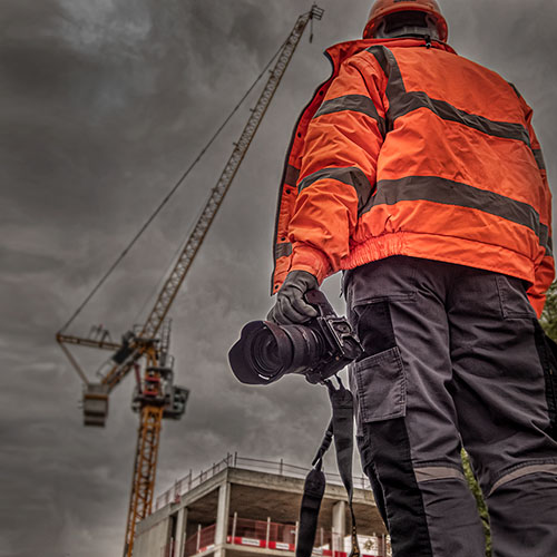 Construction photographer in Hi-viz on a site in the UK