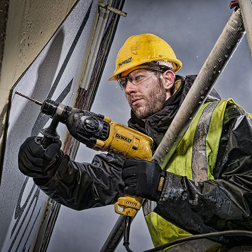 An example of commercial photography showing a worker with a deWalt drill at a London construction site