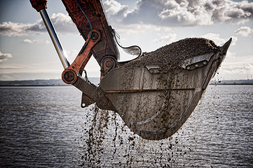 Excavating gravel from the sea