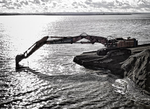 Excavator photographed working on the coast at the new London Gateway port in Essex