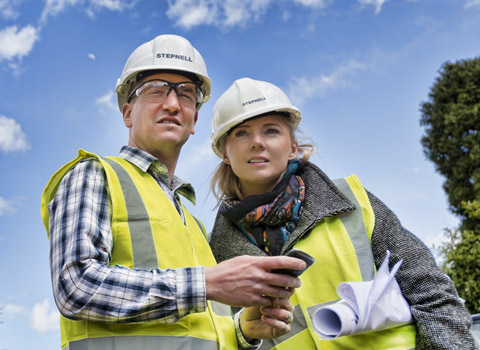 Male and female construction workers on a site
