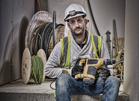 Photograph of a worker resting on a construction site in London