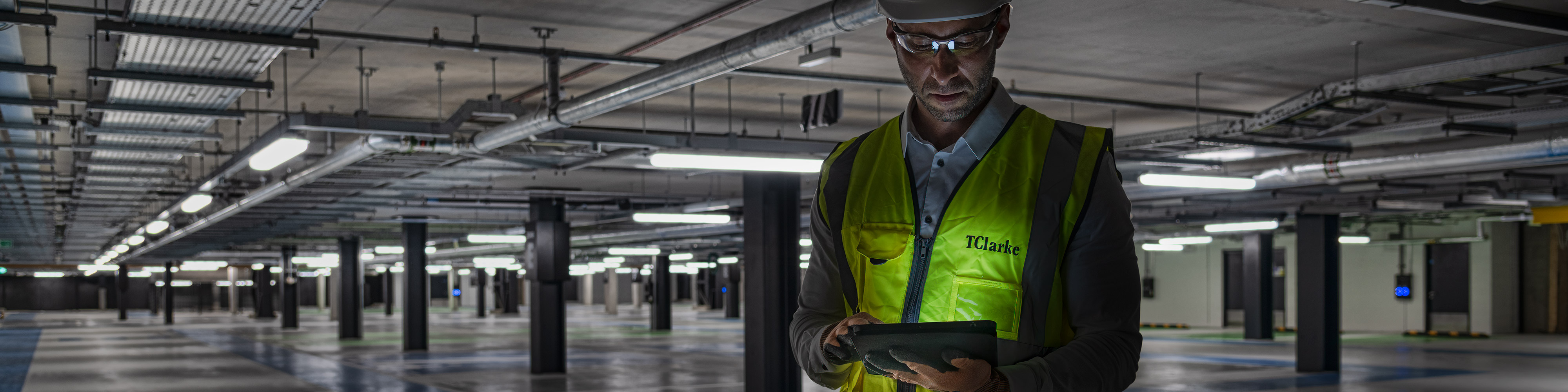 Construction worker using a digital tablet on a construction site to contact a photographer