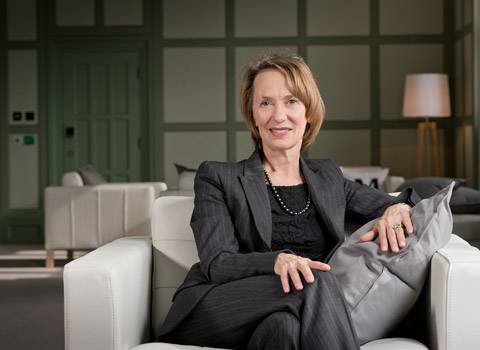 Editorial photograph of a woman on a sofa in an office