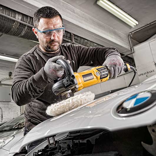 Mechanic working on a car in a bodywork garage in East London
