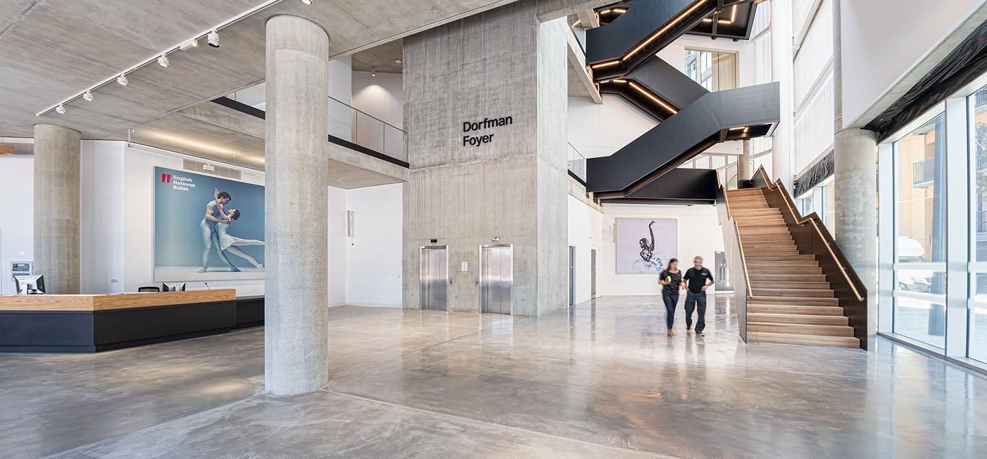 Two people walking through the interior of the ENB building in East London