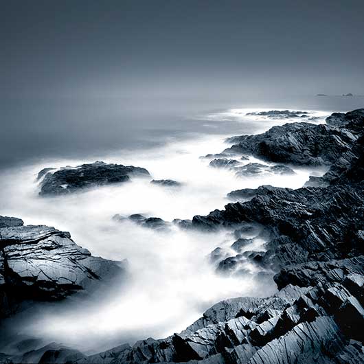 A rocky coast in Cornwall shot with a long exposure to make the sea smooth