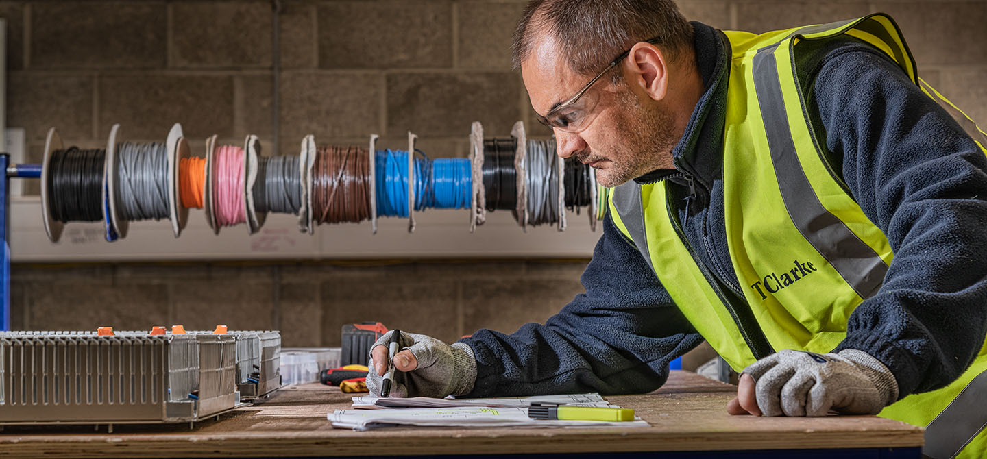 Worker in an industrial setting estimating amounts to work out costs for a project