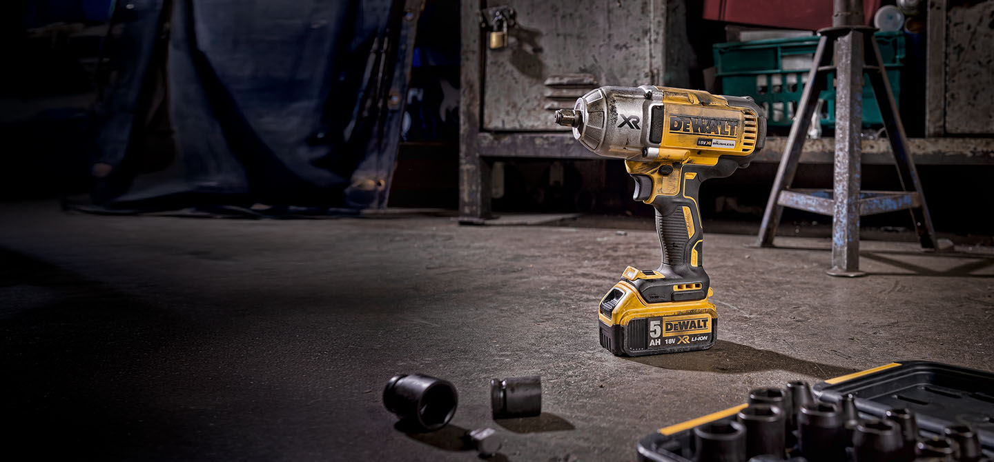 A yellow deWalt power tool photographed in a workshop