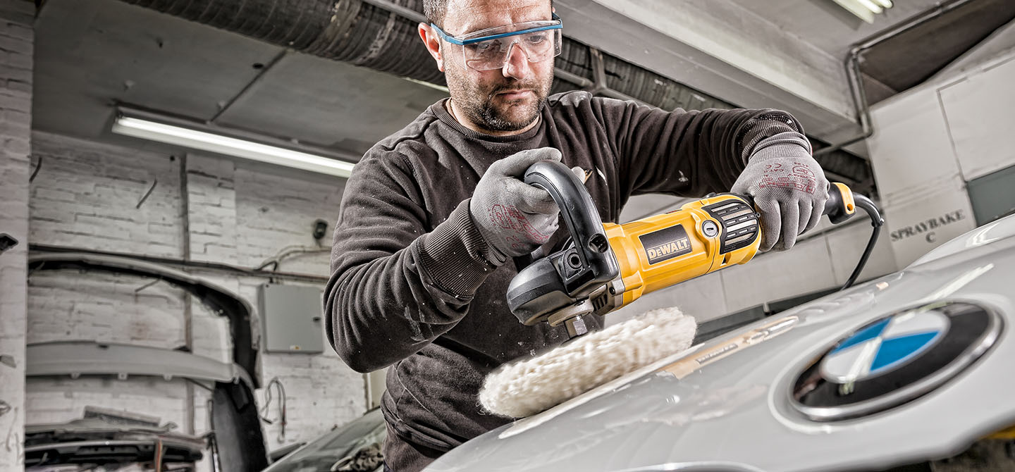 A deWalt rotary polisher being used in a car body repair shop