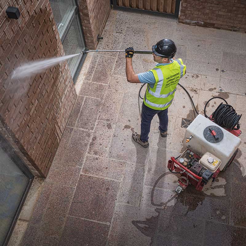 Using a jet wash to clean bricks on a new house