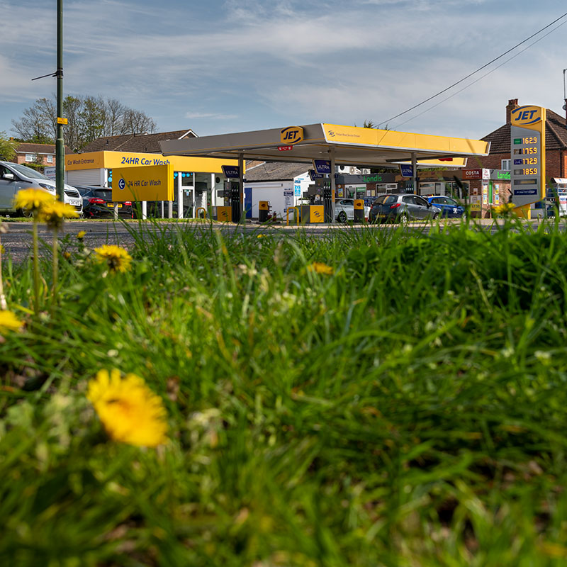 Low angle shot of a petrol station with grass in the foreground